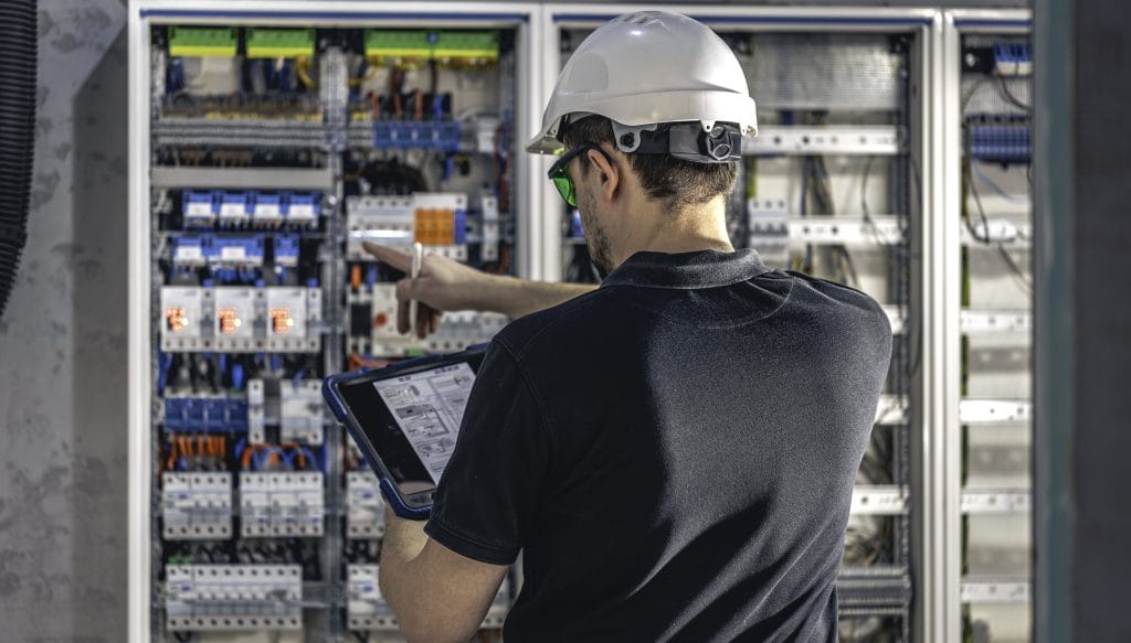 SERIES Từ vựng tiếng Đức chuyên ngành #7 - Chủ đề: Kỹ thuật Điện - Điện tử 4 man electrical working switchboard with fuses uses tablet