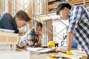 group smart asian architect interior design team consulting with constrction engineer work brainstrom meeting with house project blueprint home mockup house renovation structure background